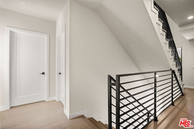 stairs featuring wood-type flooring