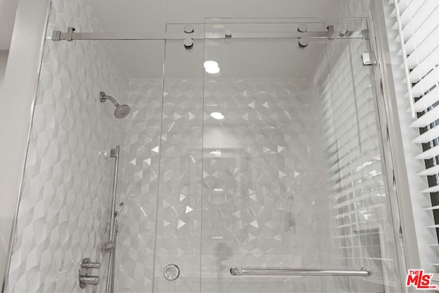 bathroom with a shower with shower door