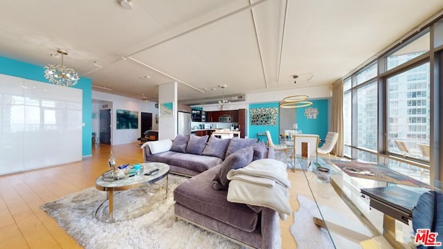 living room with a wall of windows and light wood-type flooring