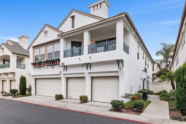 view of front facade with a balcony and a garage