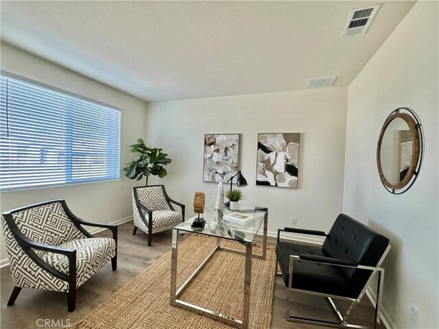 sitting room with hardwood / wood-style floors