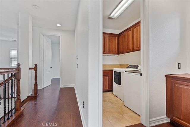 kitchen featuring light wood-type flooring and washing machine and clothes dryer