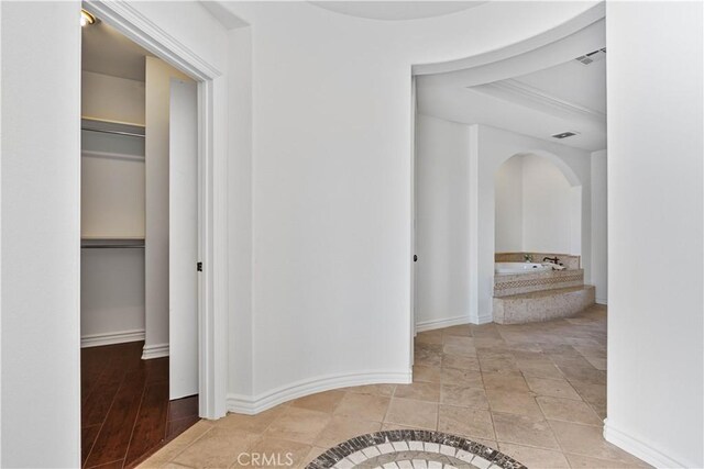 corridor featuring light tile patterned floors