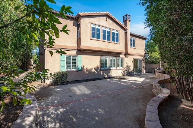 back of house with a patio area