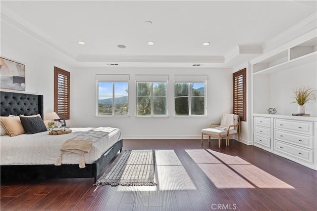 bedroom with a raised ceiling, dark wood-type flooring, and crown molding