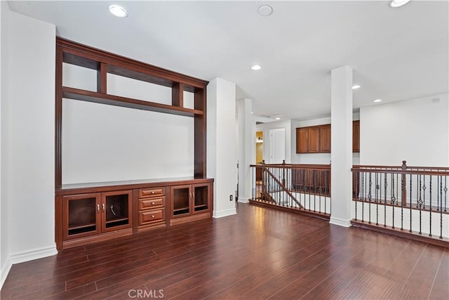 unfurnished living room featuring dark hardwood / wood-style floors