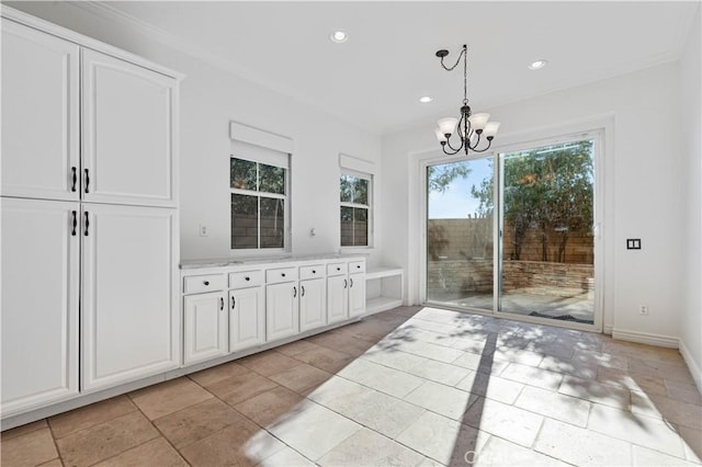 interior space with crown molding and a notable chandelier