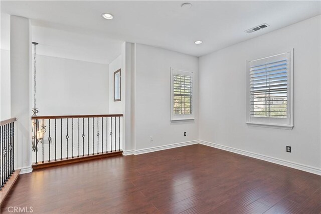 empty room featuring dark hardwood / wood-style flooring