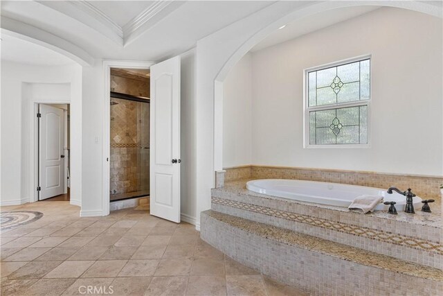 bathroom featuring a raised ceiling, tile patterned flooring, ornamental molding, and shower with separate bathtub