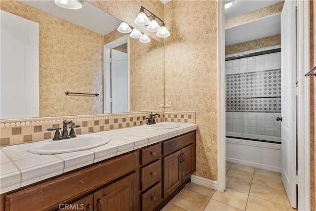 bathroom featuring decorative backsplash, tile patterned floors, and vanity