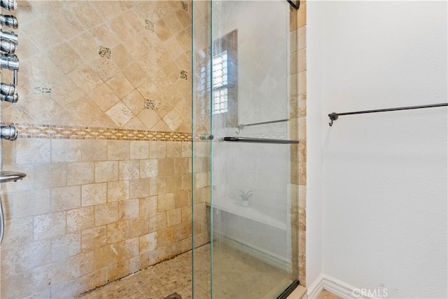 bathroom with a shower with shower door