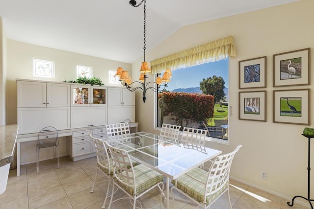 dining area with light tile patterned floors, lofted ceiling, and plenty of natural light