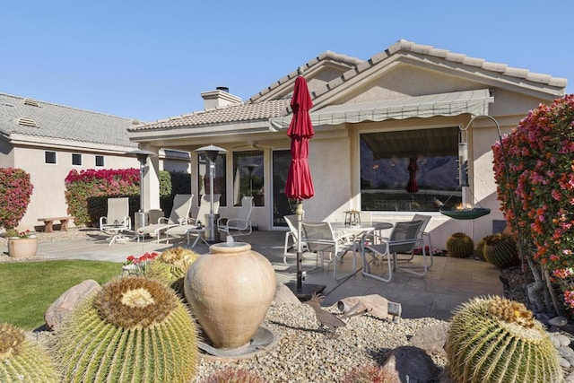 rear view of property featuring a patio area