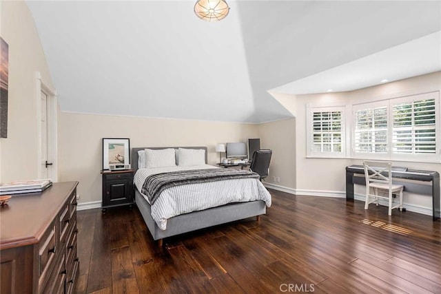 bedroom featuring vaulted ceiling and dark hardwood / wood-style flooring