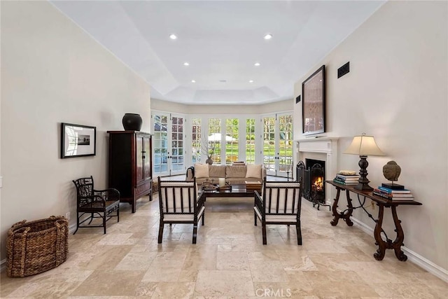 living area with a tray ceiling