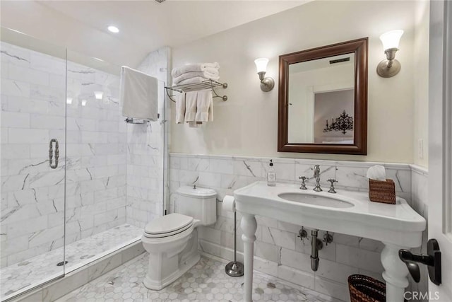 bathroom with toilet, tile walls, tile patterned floors, walk in shower, and sink