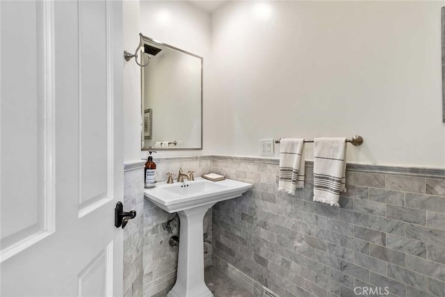 bathroom with tile walls and sink