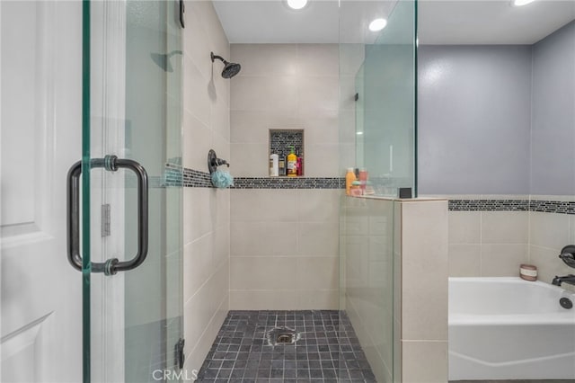 bathroom with shower with separate bathtub