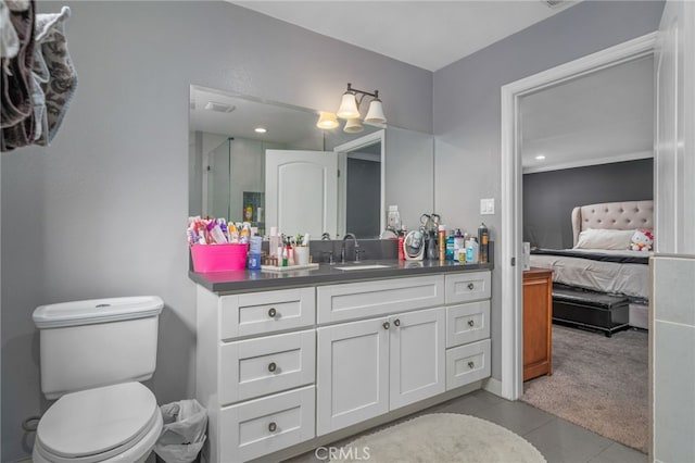 bathroom featuring toilet, tile patterned floors, and vanity