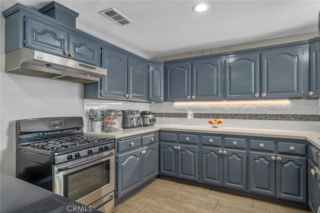 kitchen featuring gas range and blue cabinets