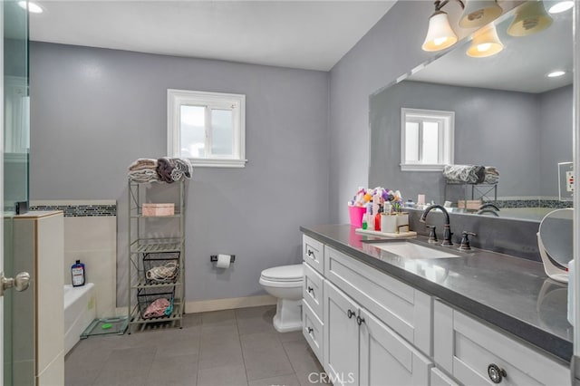 bathroom featuring toilet, a healthy amount of sunlight, vanity, and tile patterned floors