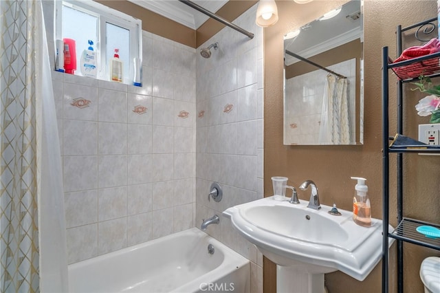 bathroom with ornamental molding, shower / tub combo with curtain, and sink