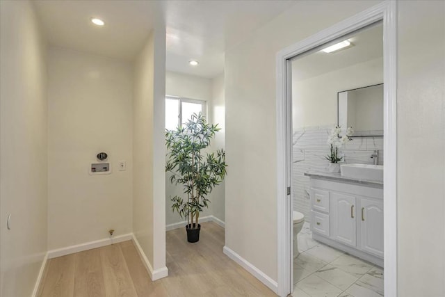 bathroom with backsplash, toilet, and vanity