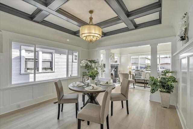 dining space with ornate columns, beamed ceiling, and coffered ceiling