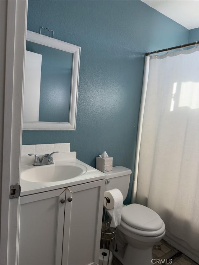 bathroom featuring toilet and vanity