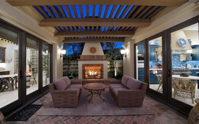 view of patio / terrace featuring french doors and an outdoor living space with a fireplace