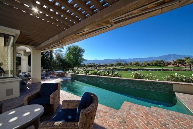 view of swimming pool featuring a pergola, a mountain view, and a patio