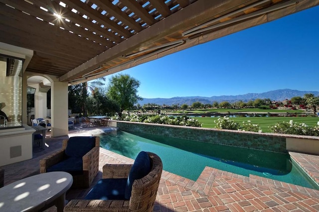 view of swimming pool with a pergola, a mountain view, and a patio