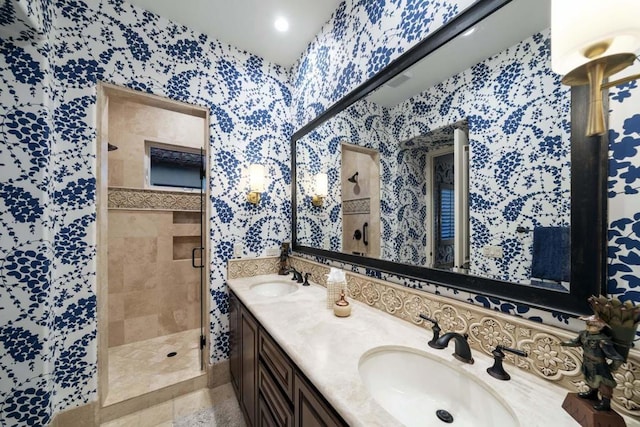 bathroom featuring a shower with shower door and vanity