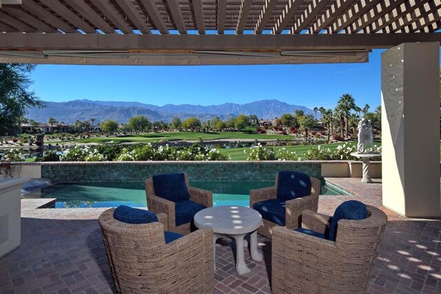 view of patio / terrace with a pergola and a mountain view