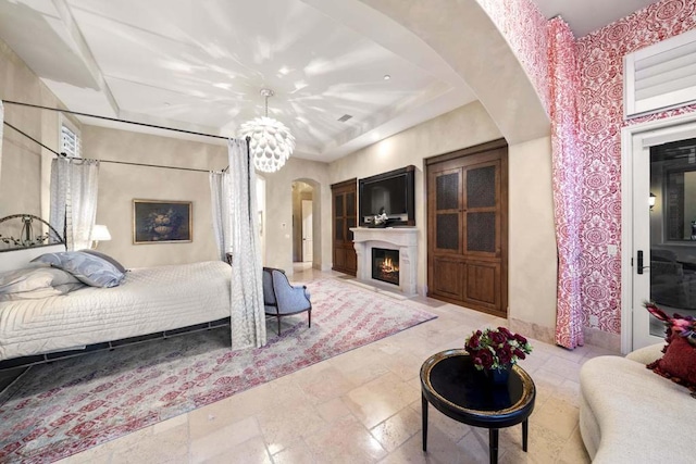 bedroom with a chandelier and a raised ceiling