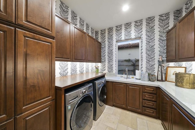 laundry room with washer and clothes dryer, sink, and cabinets