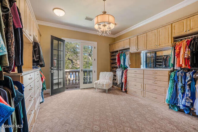 spacious closet featuring light carpet, an inviting chandelier, and french doors