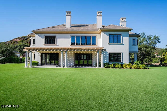 rear view of house with a yard