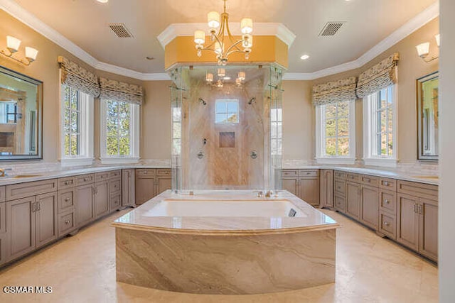 bathroom with ornamental molding, plenty of natural light, and a notable chandelier