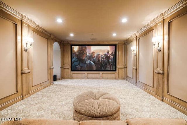 home theater room featuring light carpet and crown molding