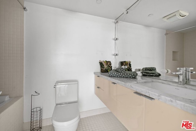 full bathroom featuring toilet, tile patterned flooring, tiled shower / bath combo, and vanity