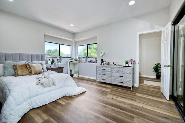 bedroom with hardwood / wood-style floors