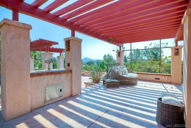 view of patio / terrace featuring a pergola and a mountain view