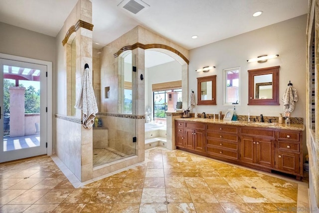 bathroom featuring plenty of natural light, an enclosed shower, and vanity