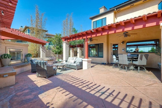 view of patio / terrace featuring ceiling fan and an outdoor living space with a fireplace