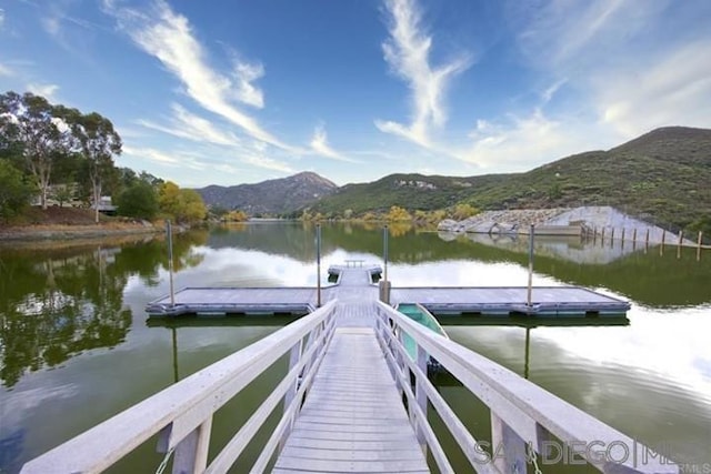 dock area featuring a water and mountain view