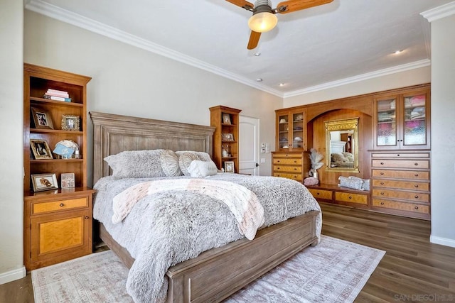 bedroom with ceiling fan, dark hardwood / wood-style floors, and crown molding