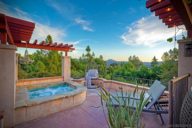 view of pool with an in ground hot tub, a patio area, and a mountain view