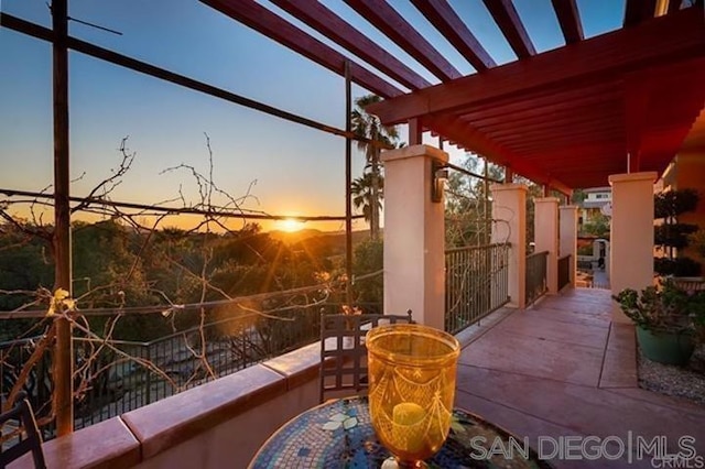 patio terrace at dusk with a pergola