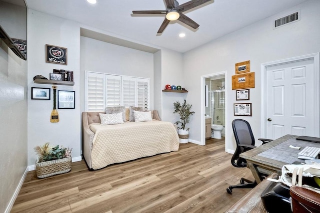 bedroom featuring ceiling fan, ensuite bathroom, and hardwood / wood-style flooring